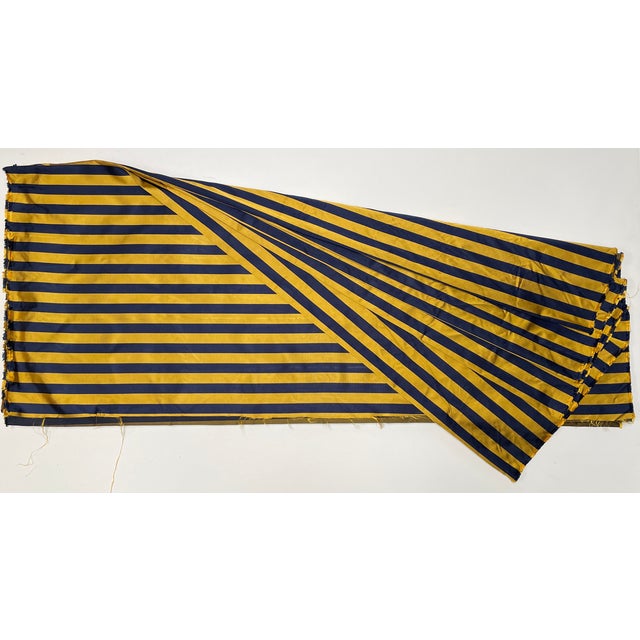 A classically colored varsity-style tie silk in navy and yellow-gold. It has a ribbed-weave texture, as ties do....