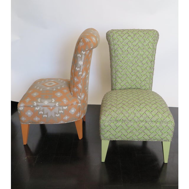 Pair of French Mid-Century upholstered side chairs with lacquer legs. Lacquer to match upholstery. Orange chair has tribal...