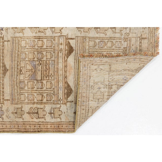 Exuding organic warmth and quiet luxury, this vintage hand-knotted wool rug features a sophisticated neutral palette of...