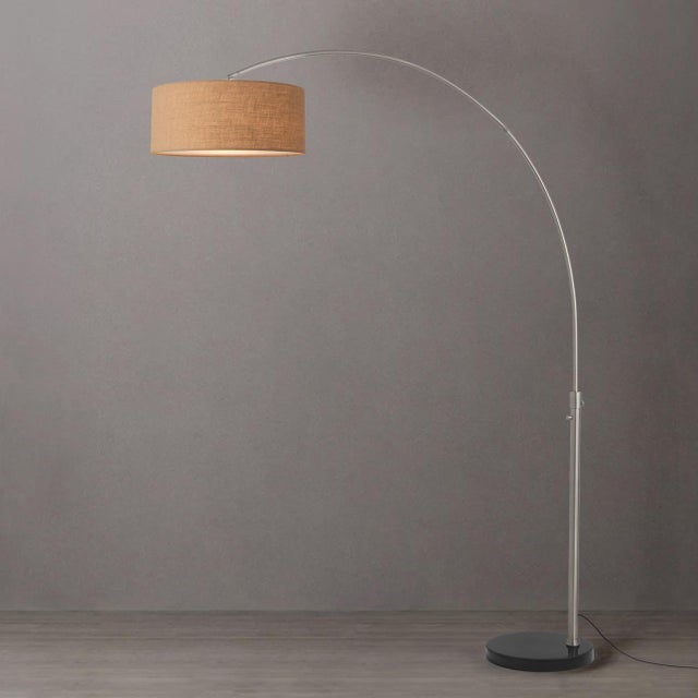 Featuring a sweeping, gracefully arched silhouette, the Float Arc Lamp is a modern masterpiece designed by Peter Morelli...