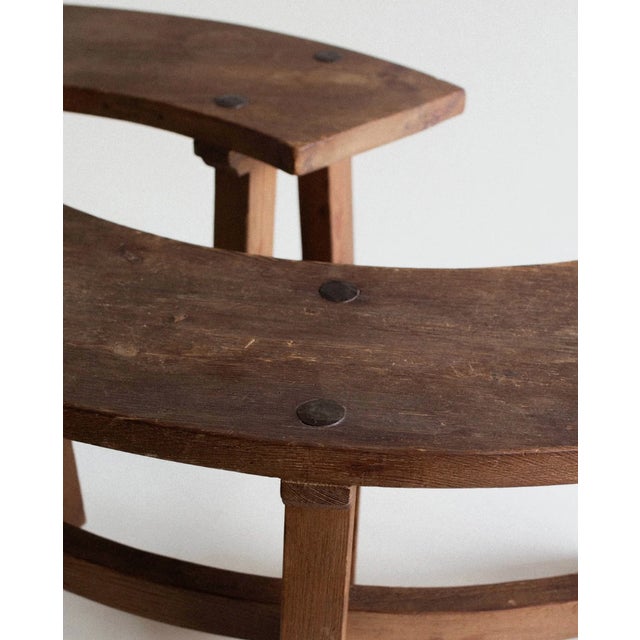 A pair of curved benches in solid pine, built with the blunt, structural confidence of French brutalist furniture from the...