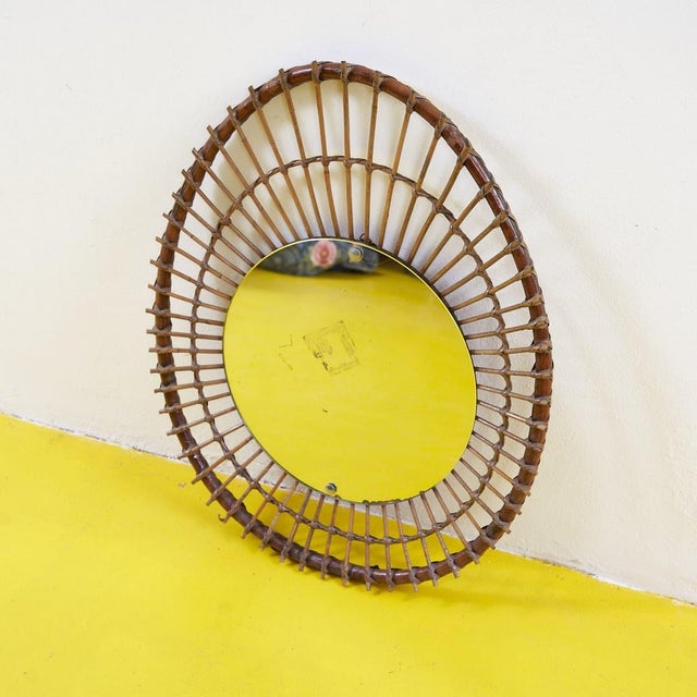 This charming vintage-design mirror is a true collector's piece, featuring a woven rattan frame that lends a natural,...