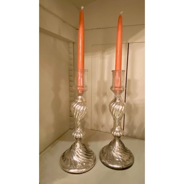 A pair of 19th century mercury glass candlesticks from France.