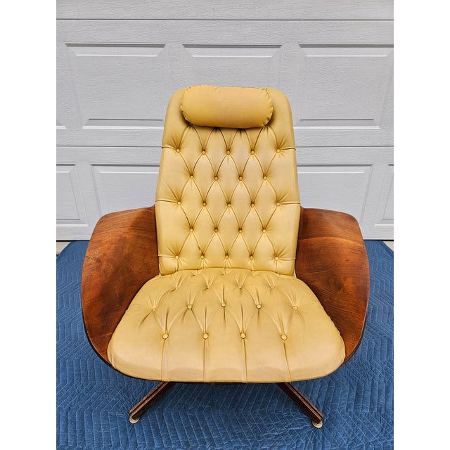 A Mid-Century Modern classic, Mr. Chair and matching ottoman by George Mulhauser for Plycraft. This chair features walnut,...
