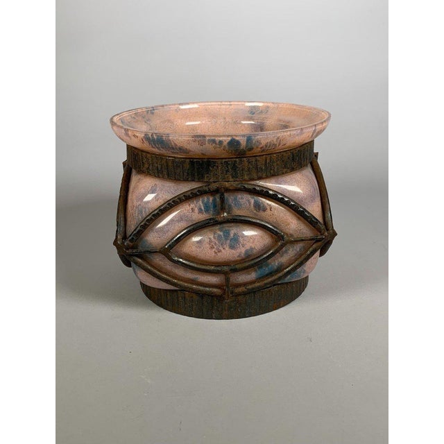 Blown glass vase in a wrought iron frame. Signed Lorrain Nancy. Pink and nuanced blue glass. French work, early 20th...