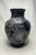 The floral motif is enhanced in a white-washed patina on a dark background on this substantial size vase. The bulbous...