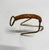 Modernist Wine Bottle Holder in brass with braided leather handle. This piece is attributed to the mentioned...