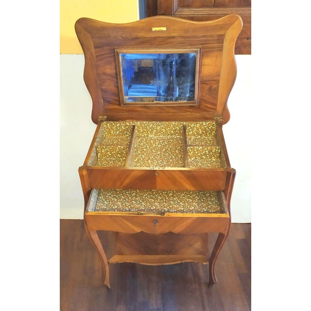 Cherry wood sewing cabinet, fine diamond pattern. Folding top with a mirror and a compartment inside. An underlying drawer...