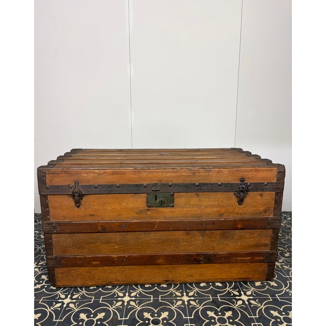 Antique slat trunk (often called a steamer trunk), which was widely popular for travel in the late 19th and early 20th...