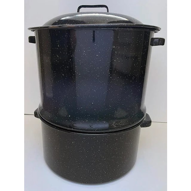 Vintage New England style black speckled enamelware two chamber steamer pot with working spigot. The top section has a...