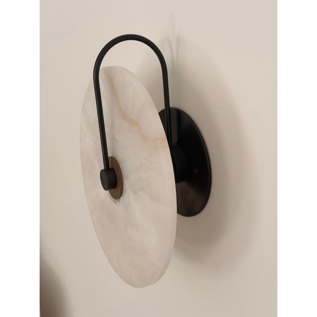 Single sconce by Allied Maker with alabaster diffuser and Maker's Black and Bronze accents. Excellent to perfect...