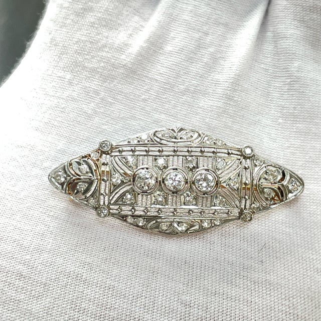 Discover the timeless elegance of our Antique Art Deco Brooch, a stunning piece that seamlessly blends luxury and history....