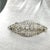Discover the timeless elegance of our Antique Art Deco Brooch, a stunning piece that seamlessly blends luxury and history....