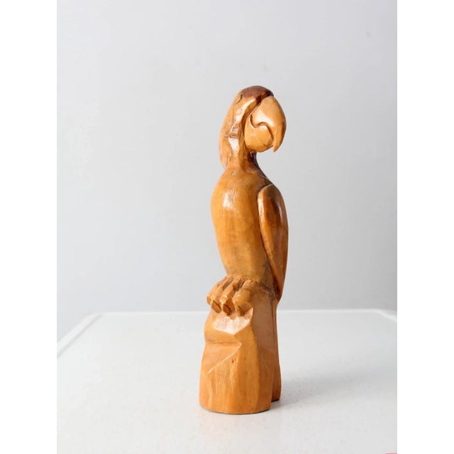 This is a vintage hand-carved wooden parrot figurine.
