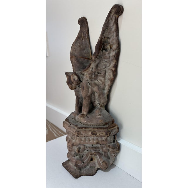 An extraordinary and highly sculptural winged California mountain lion above bighorn ram heads cast iron element believed...