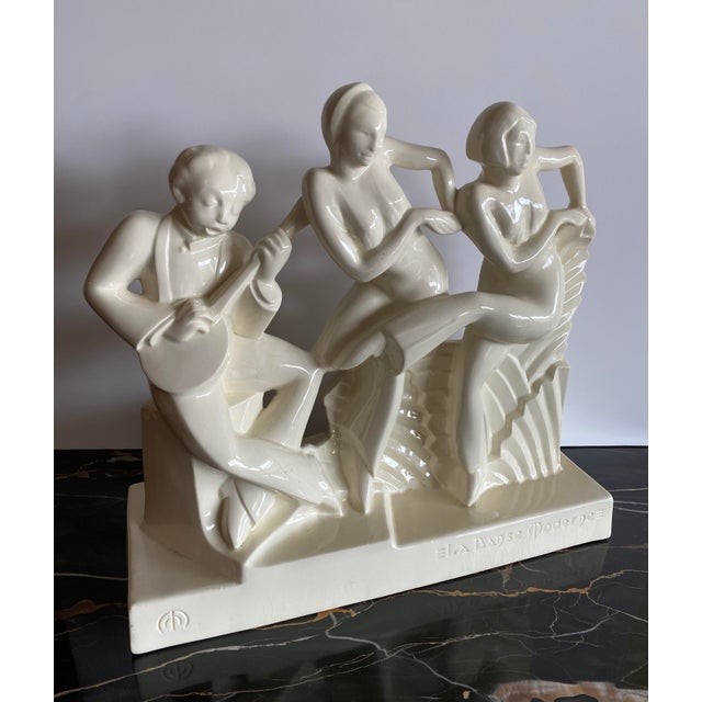 Charles Catteau (French, 1880-1966) for Boch Frères Keramis La Danse Moderne ceramic figurine depicting a man playing an...