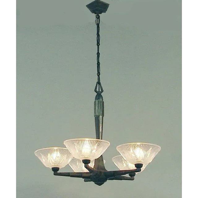 Offering an especially well-designed French Art Deco chandelier, the spare geometric design so appropriate to its period....