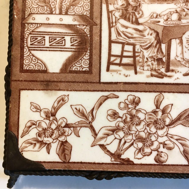 This English Victorian Aesthetic Movement tile features a tea party and floral, geometric border. The series of this tile...