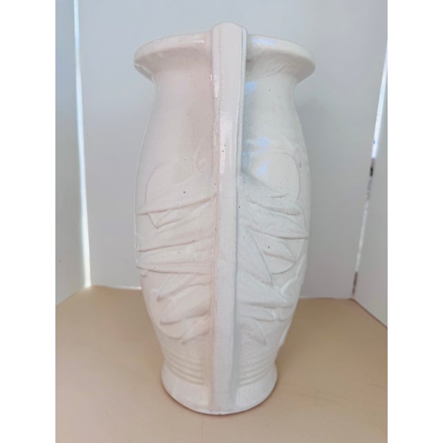 favorite among McCoy fans is this tall vase in a nice white satin glaze. Styled with a leaf like patter on the sides and 2...