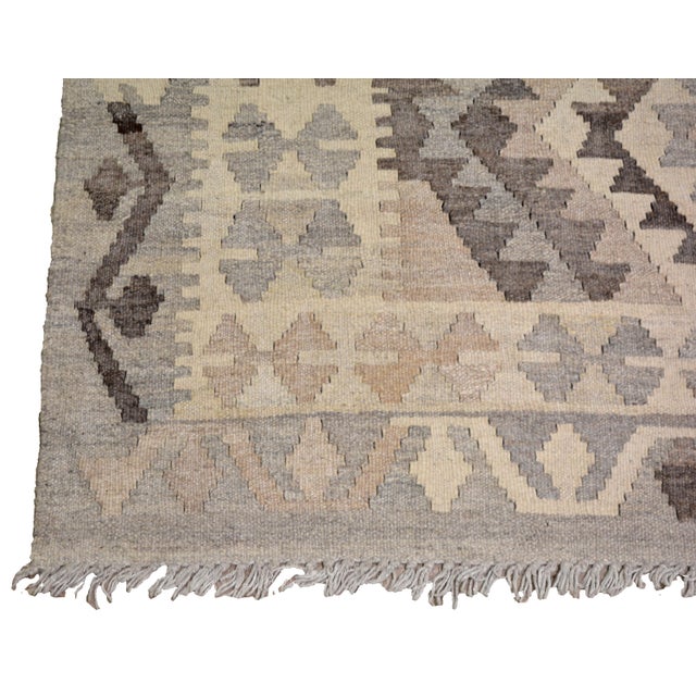 Afghan Navajo Flatweaved with care using traditional rug-making techniques, this wool rug blends timeless craftsmanship...