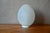 Original, soft, and elegant, this table lamp is crafted from Vianne glass. The egg-shaped shade is made of opalescent...