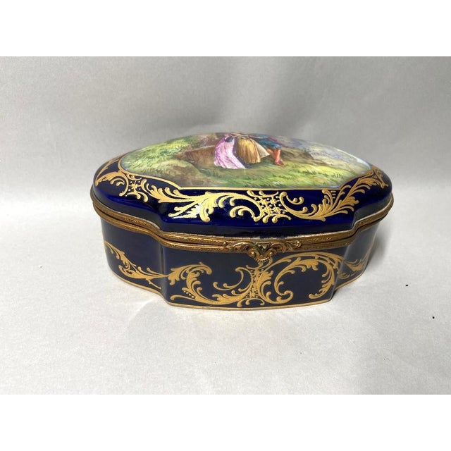 A beautiful antique French Sevres style porcelain box dating from around 1880, richly decorated in classic blue porcelain...