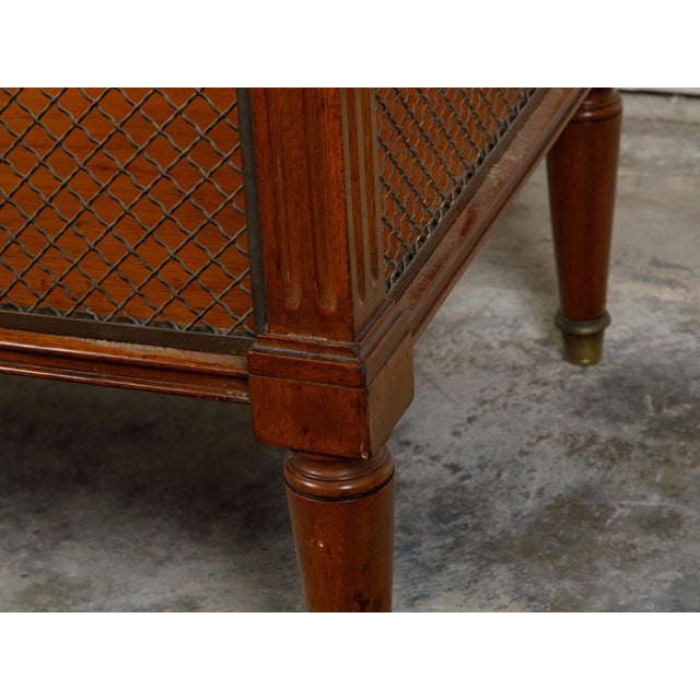 A French walnut console table from the 19th century, with white marble top, brass gallery and single drawer. Created in...