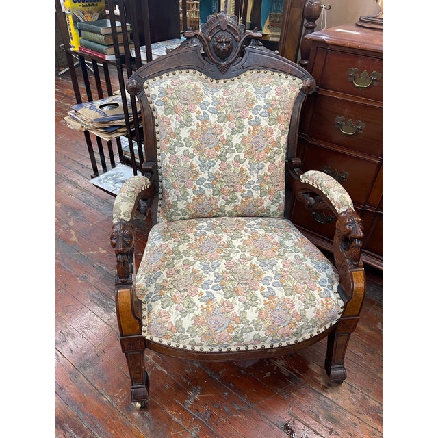 This imposing Renaissance Revival armchair is crafted from richly toned walnut and features boldly carved lion heads at...