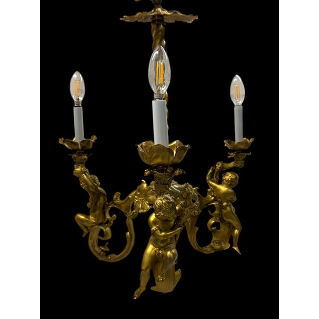 A fine 19th century French gilt bronze (ormolu) three-light chandelier, featuring a twisted central stem supporting three...