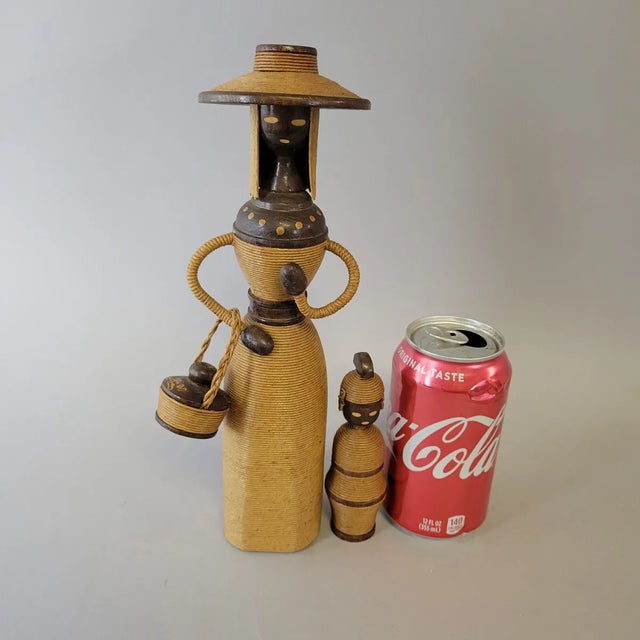 A striking pair of mid-20th century Scandinavian folk art figures, handcrafted from turned wood and meticulously wrapped...