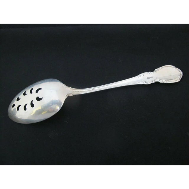 Set of 2 sterling silver Towle slotted serving spoons in classic Legato pattern. Each measures 8 1/2". Both are in...