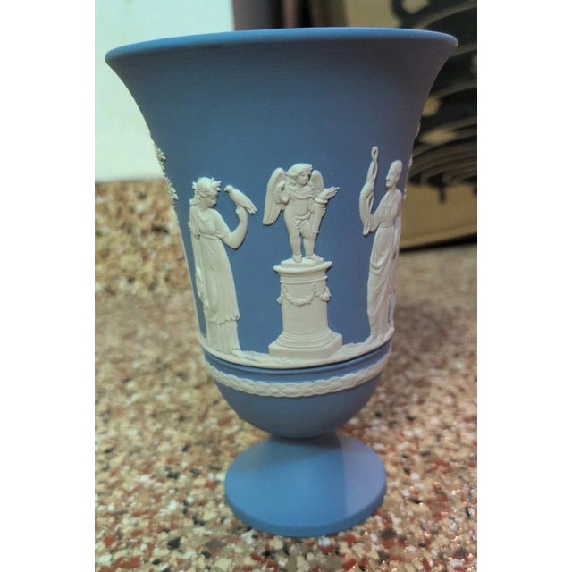 Celebrate the timeless elegance of English craftsmanship with this **Vintage Wedgwood Blue Jasperware Footed Vase**,...