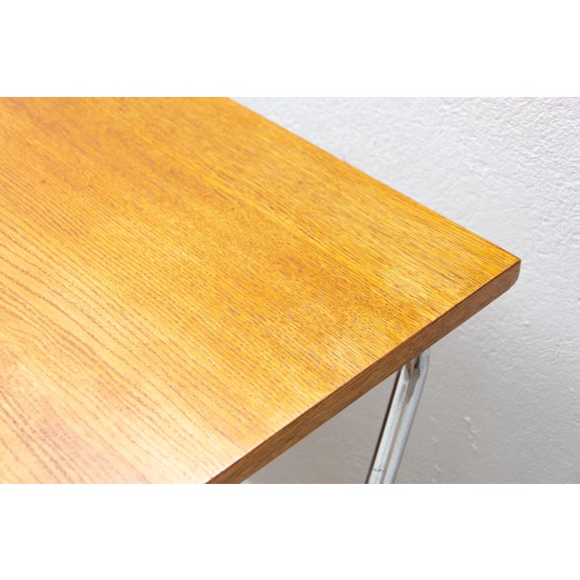 This tubular writing desk was designed by Rudolf Vichr in the 1940s and manufactured in the 1950s by Kovona. The design...