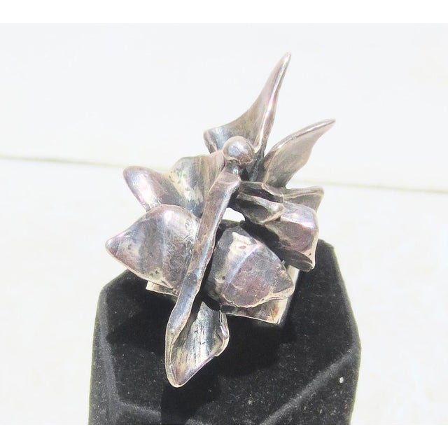 Rima sterling ring, A brutalist figure design. Floral design. Signed to the inside of the band Rima. Sterling size 7 and...