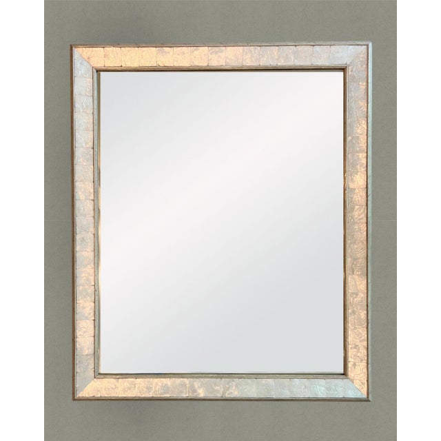 Large beveled mirror with a designer silver and mother-of-pearl frame. The mother-of-pearl is cut, arranged and polished...