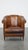 Unique vintage cognac-colored leather club chair with good seating comfort and a finish with black piping. This incredibly...