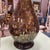 Larger scale teardrop shaped table lamp has an array of small rectangular smoke colored mirrors forming its entire base....