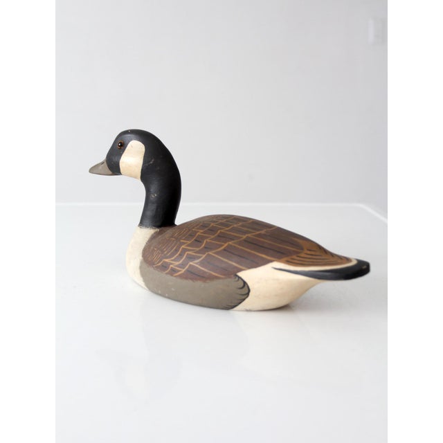 Striking vintage Canada goose decoy, hand-carved and hand-painted by J. Kubuk and dated 1989. The expressive folk art...