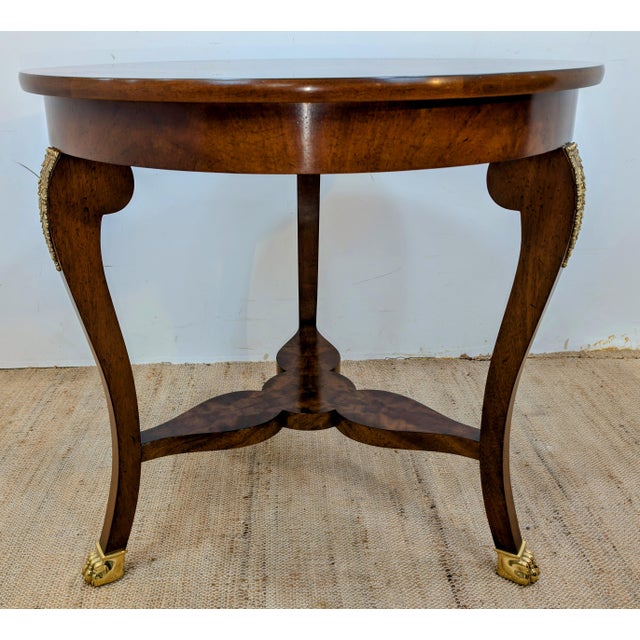 Mahogany with Satin Wood and Mahogany Parquetry top. Cabriole leg with brass acanthus leaf ormolu sitting on brass claw...