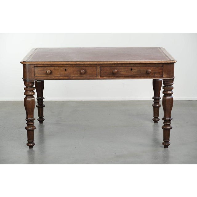 This antique English writing desk/office desk/bookcase dates from the early 19th century and features a red leather top...