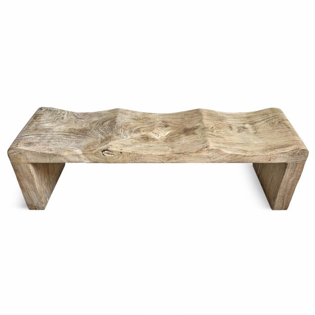 Solid teak bench with a soft wave silhouette. This sculptural bench brings organic movement and natural warmth to both...