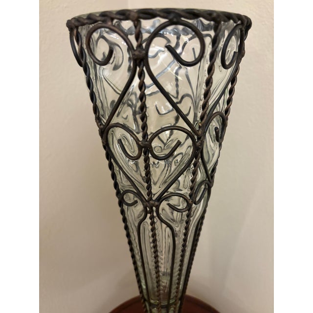 This is an amazing antique Italian vase with handblown glass into a black metal frame.