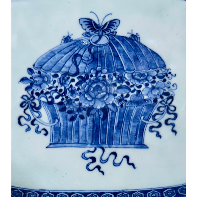 A Qing Dynasty Chinese Export blue and white dish finely hand-painted in underglaze cobalt blue with a lidded basket...