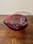 A sculptural 1960s blown studio glass bowl in the Murano attributed, featuring vibrant raspberry tones suspended in clear...