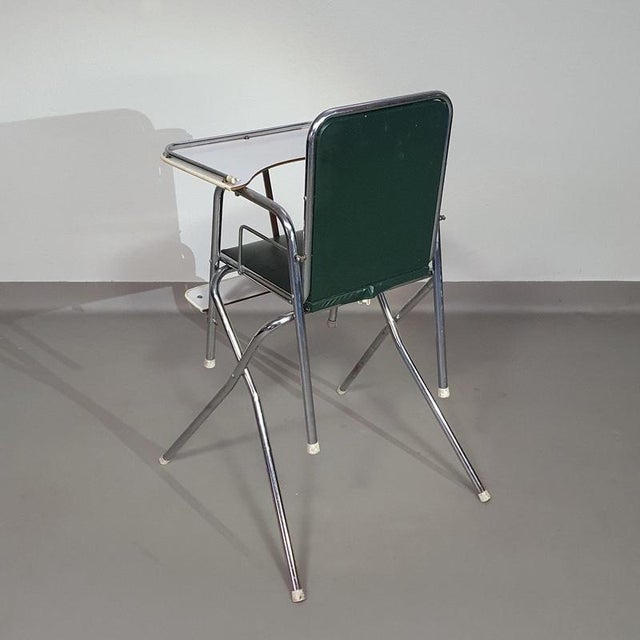 Vintage children's chair from Mutsaerts. 1972. Dark green leatherette and chrome tubes. The base of this high chair can be...