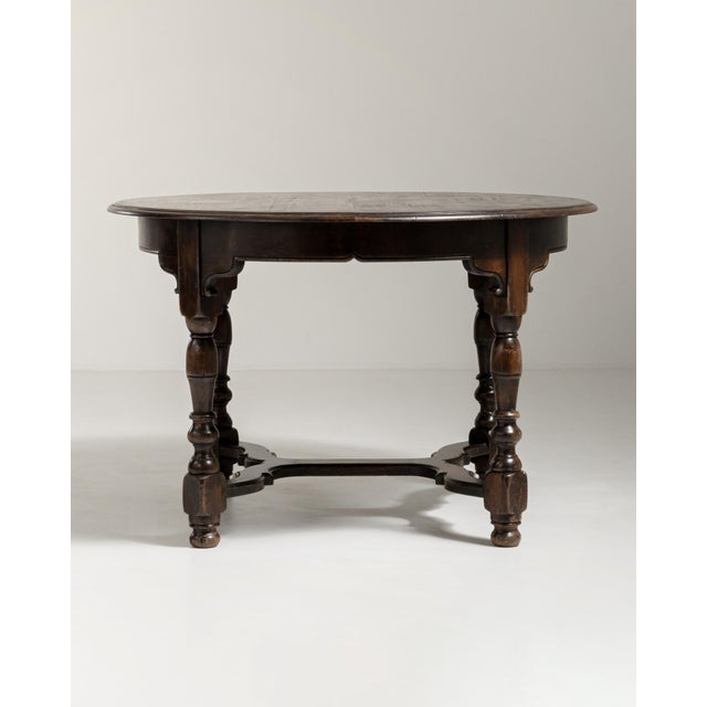 A characterful dining table featuring turned legs and a richly worn original patina that highlights its age and...