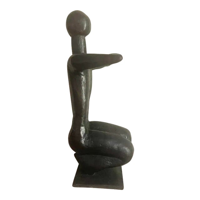 Handsome mid-century bronze sculpture in the form of a seated woman with her arms crossed. This sculpture is extremely...
