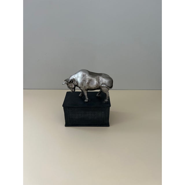 Vintage bull and bear stock market bookends featuring silver-tone metal figures mounted on black rectangular bases. Each...