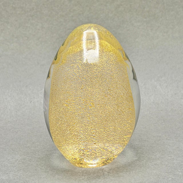 • Murano Italian art glass paperweight with shimmering gold aventurine inclusions and an oval form. • Murano attribution...