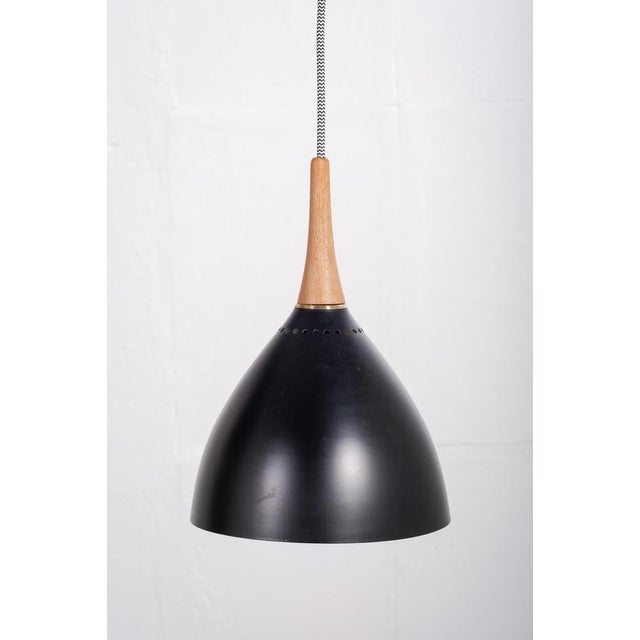 A ceiling lamp designed by Svend Aage Holm Sørensen and produced by Holm Sørensen in the 1950s. The lamp features a teak...